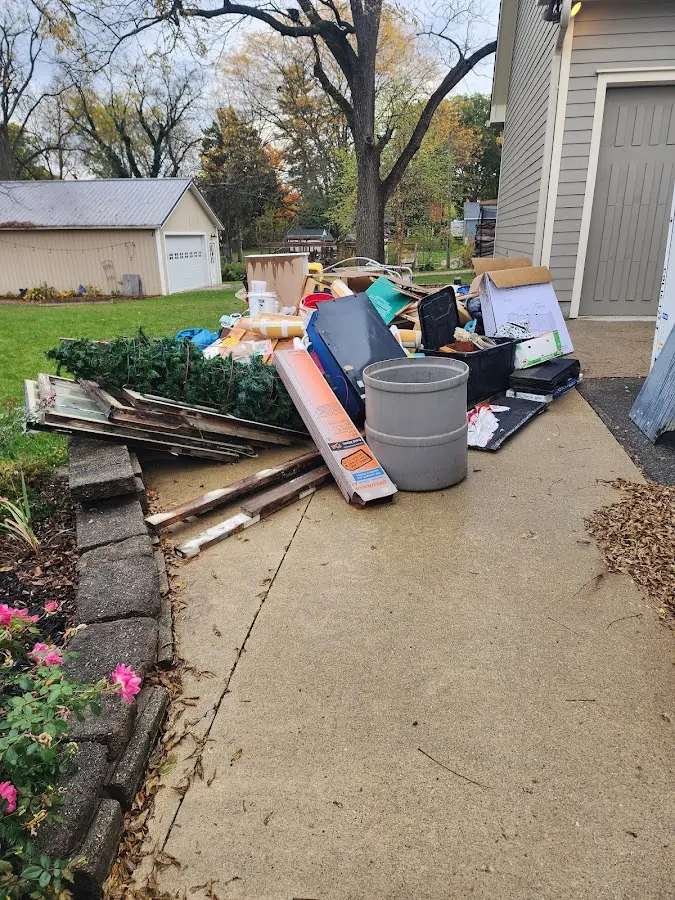 Dumpster being loaded with debris for Estate Cleanout Dumpster Rental in Bayou Cane